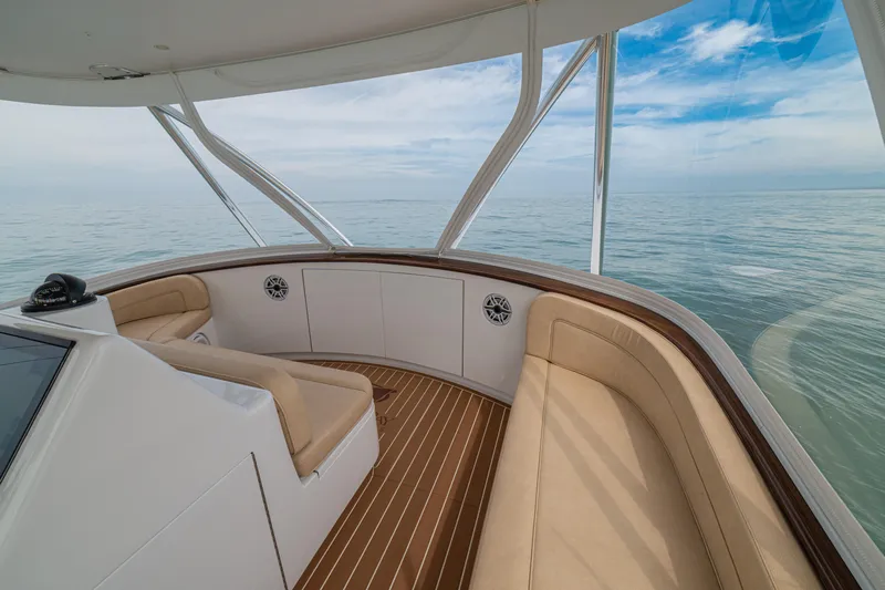  Yacht Photos Pics 2022 Jarrett Bay Flybridge Express interior with beige seating and ocean view.
