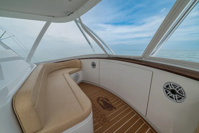  Yacht Photos Pics 2022 Jarrett Bay Flybridge Express interior with beige seating and ocean view.