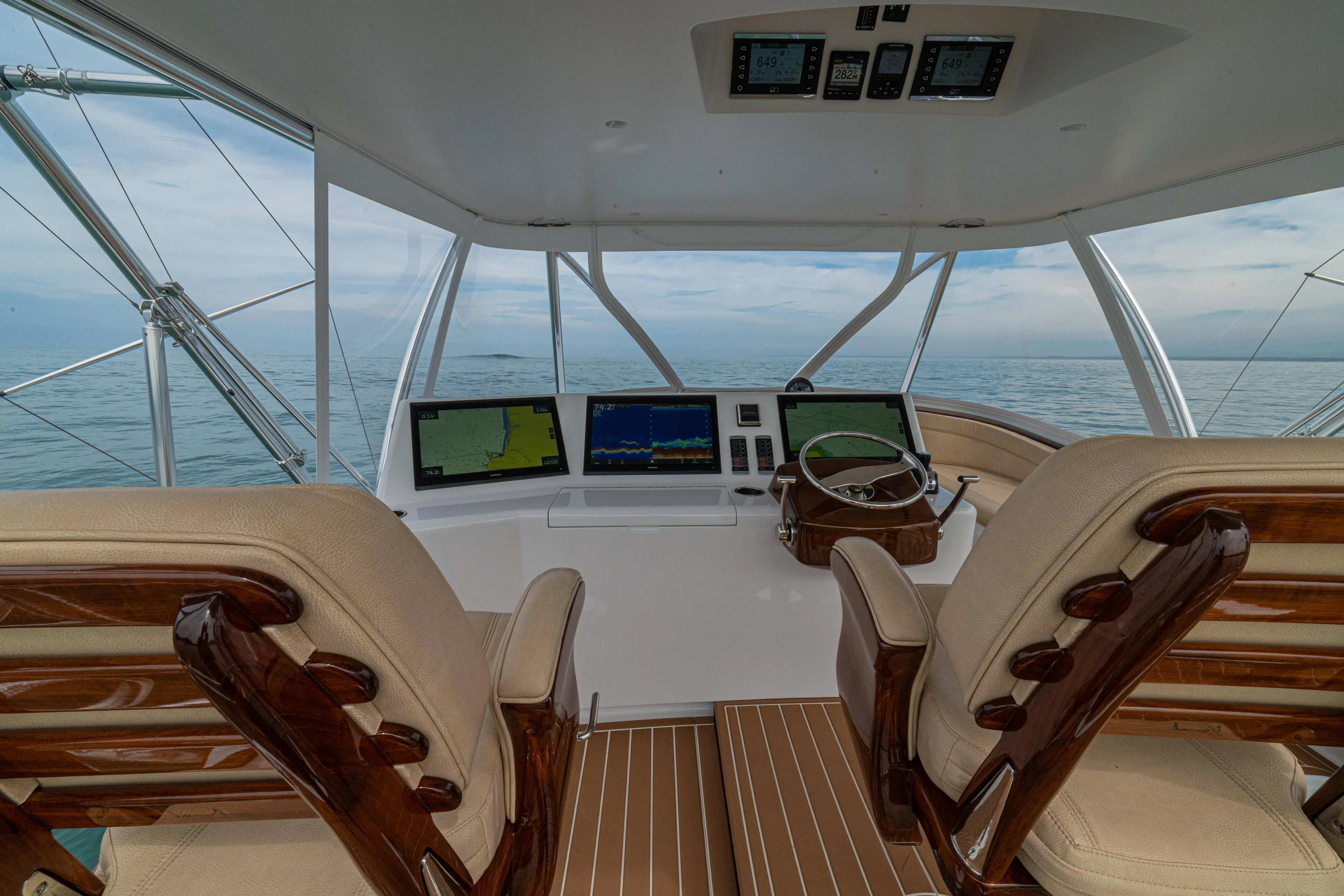  Yacht Photos Pics 2022 Jarrett Bay Flybridge Express helm with dual screens and ocean view.