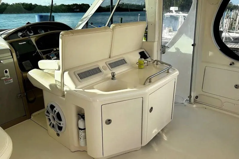  Yacht Photos Pics 2003 Sea Ray 390 Motor Yacht interior with helm, sink, and seating area.