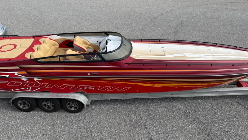  Yacht Photos Pics 2007 Fountain 42 Lightning speedboat with red and white design on a trailer.