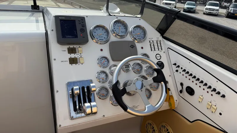  Yacht Photos Pics Dashboard of a 2007 Fountain 42 Lightning boat with gauges and steering wheel.