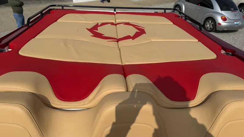  Yacht Photos Pics 2007 Fountain 42 Lightning boat with red and beige upholstery, parked near a silver car.