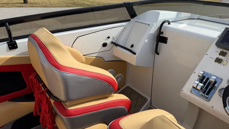  Yacht Photos Pics 2007 Fountain 42 Lightning boat interior with red and beige seating and control panel.