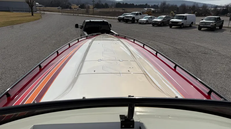  Yacht Photos Pics 2007 Fountain 42 Lightning boat on trailer, parked in a lot with several vehicles.