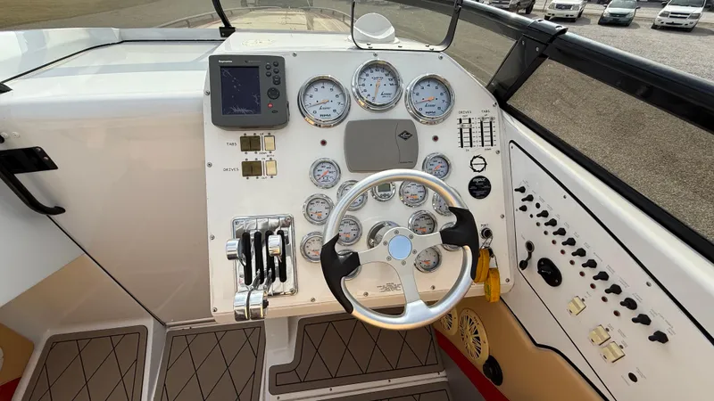  Yacht Photos Pics 2007 Fountain 42 Lightning boat dashboard with gauges and steering wheel.