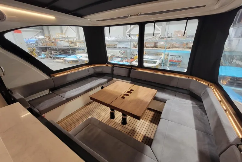 Soul Yacht Photos Pics Luxurious interior of 2025 Marex 440 Gourmet Cruiser with elegant seating and wooden table.