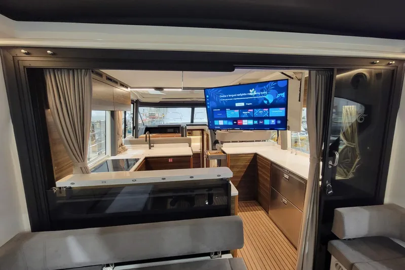Soul Yacht Photos Pics Interior of 2025 Marex 440 Gourmet Cruiser with modern kitchen and large TV screen.