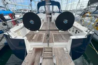 2009 Dufour 45E Performance yacht with wooden deck, docked at marina.