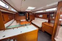 Luxurious interior of 2009 Dufour 45E Performance yacht with wood finish and seating area.
