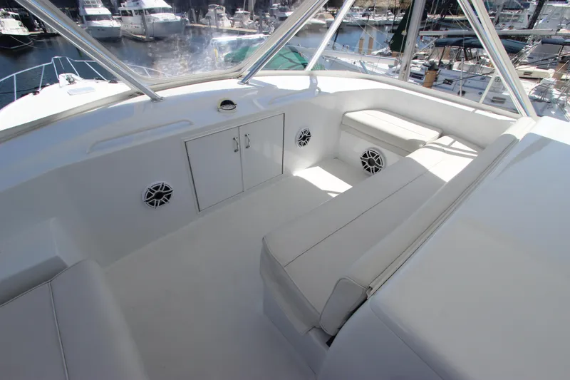  Yacht Photos Pics 2004 Hatteras 60 Convertible yacht interior with white seating and storage, docked at marina.