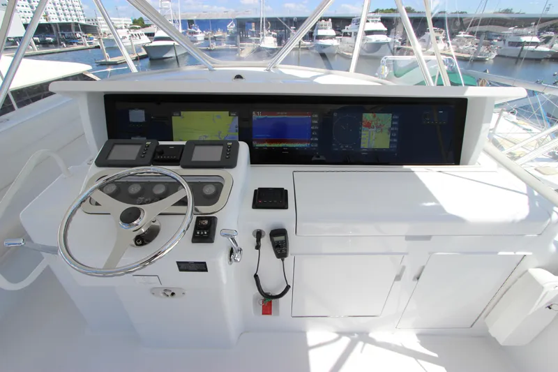  Yacht Photos Pics Helm of 2004 Hatteras 60 Convertible yacht with navigation screens and controls.