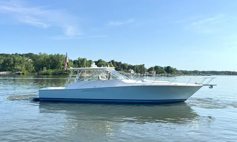 Peace Out Yacht Photos Pics 2007 Viking 52 Open yacht cruising on a calm lake under a clear blue sky.