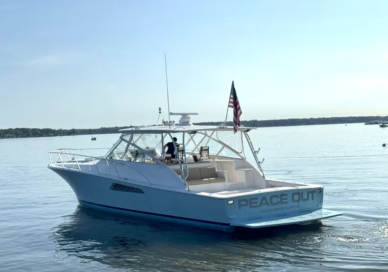 Peace Out Yacht Photos Pics 2007 Viking 52 Open yacht on calm water, displaying "Peace Out" on the stern.