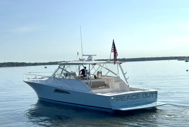 Peace Out Yacht Photos Pics 2007 Viking 52 Open yacht on calm water, displaying "Peace Out" on the stern.