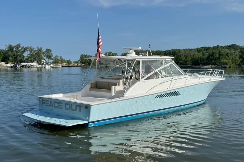 Peace Out Yacht Photos Pics 2007 Viking 52 Open yacht on calm water, featuring "Peace Out" on the stern.