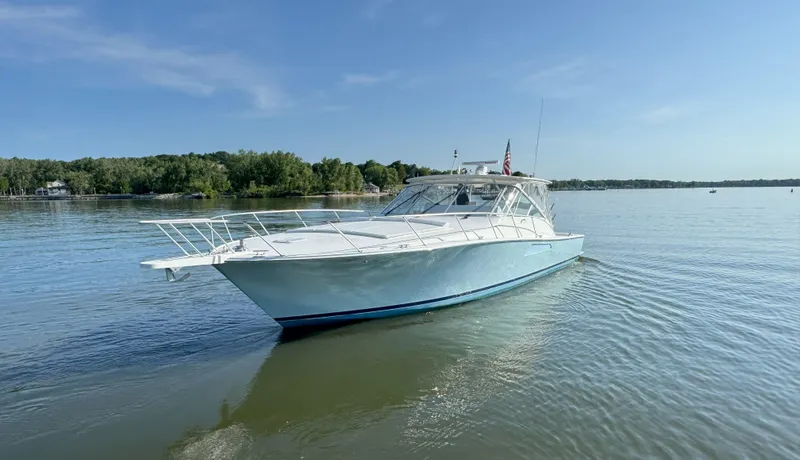 Peace Out Yacht Photos Pics 2007 Viking 52 Open yacht on calm water, clear sky, and lush shoreline.