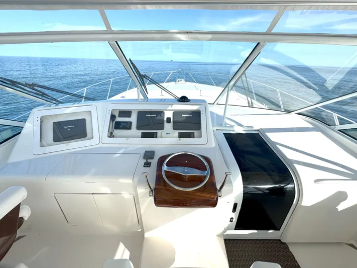 Peace Out Yacht Photos Pics 2007 Viking 52 Open yacht helm with navigation equipment, steering wheel, and ocean view.