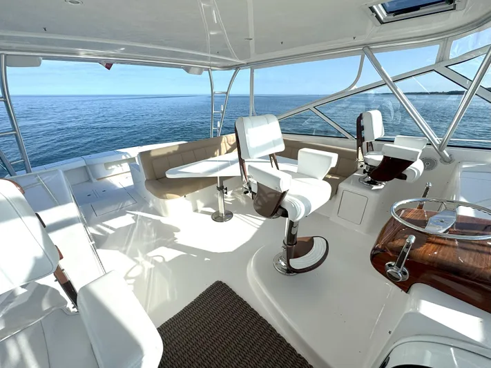 Peace Out Yacht Photos Pics Luxurious 2007 Viking 52 Open yacht interior with white seating and ocean view.