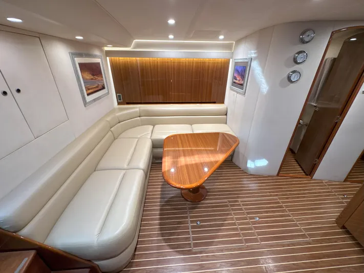 Peace Out Yacht Photos Pics Luxurious interior of 2007 Viking 52 Open yacht with leather seating and wooden table.