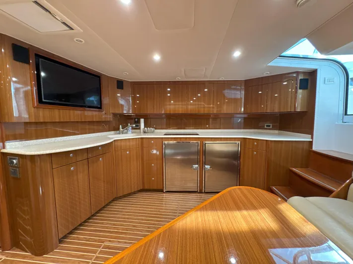 Peace Out Yacht Photos Pics Luxurious 2007 Viking 52 Open yacht interior with modern kitchen and wooden cabinetry.