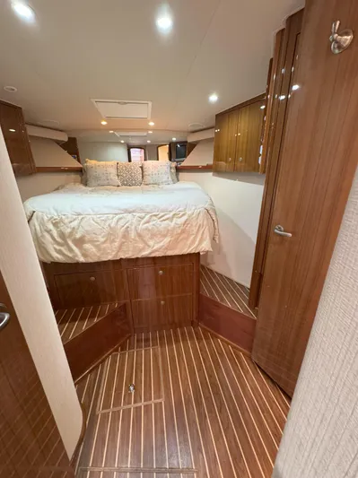 Peace Out Yacht Photos Pics Luxurious cabin interior of 2007 Viking 52 Open yacht with wood finish and cozy bed.