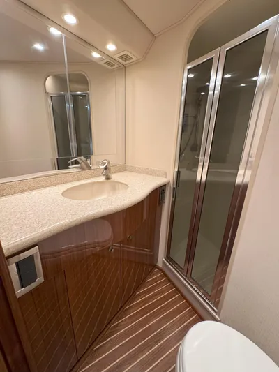 Peace Out Yacht Photos Pics Luxurious bathroom in 2007 Viking 52 Open yacht with modern fixtures and wood accents.