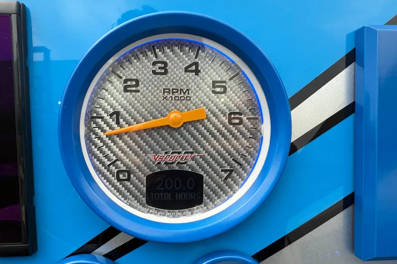  Yacht Photos Pics RPM gauge of 2021 Velocity 290sc with carbon fiber background and blue trim.