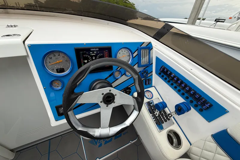  Yacht Photos Pics 2021 Velocity 290sc boat dashboard with steering wheel, gauges, and control panel.