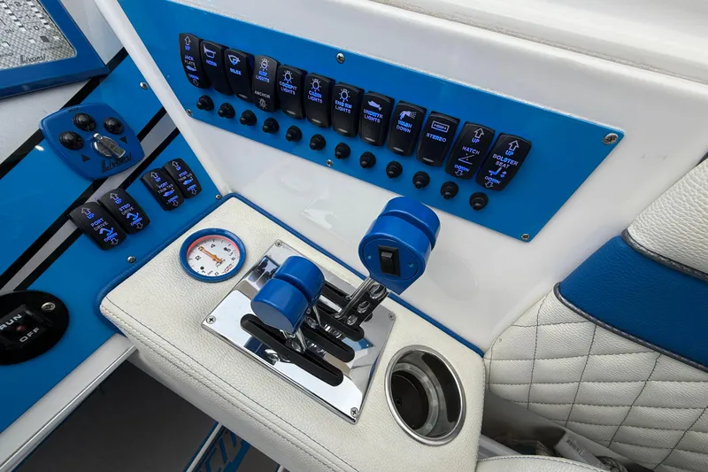  Yacht Photos Pics Control panel of a 2021 Velocity 290sc boat with switches and throttle levers.