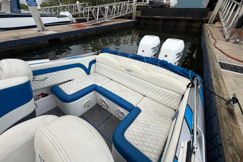  Yacht Photos Pics 2021 Velocity 290sc boat with blue and white interior, docked at marina.
