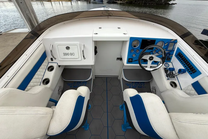  Yacht Photos Pics Interior of a 2021 Velocity 290sc boat with blue and white seating and dashboard.