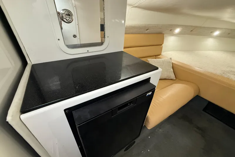  Yacht Photos Pics Interior of 2021 Velocity 290sc boat with kitchenette and seating area.