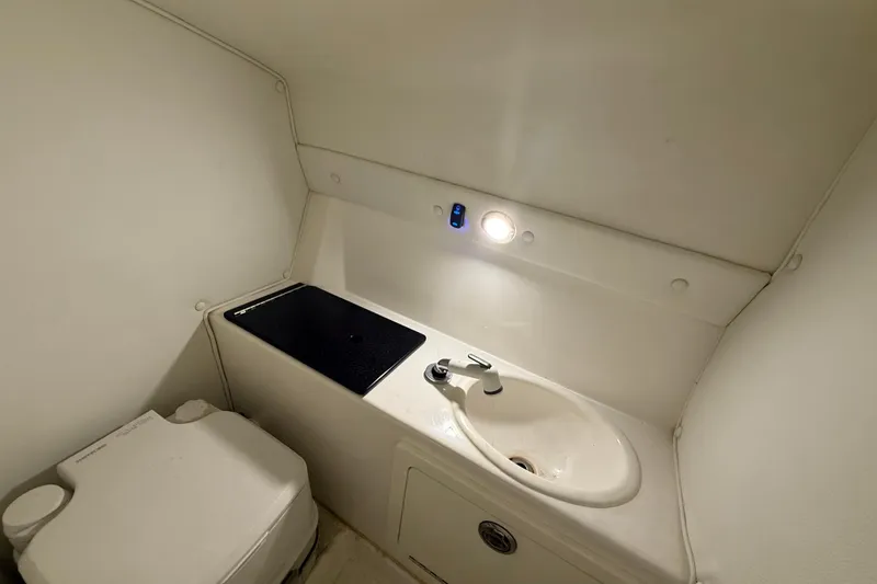  Yacht Photos Pics Compact bathroom in 2021 Velocity 290sc boat with sink and toilet.