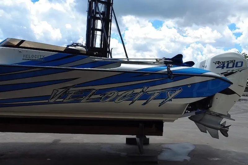  Yacht Photos Pics 2021 Velocity 290sc speedboat with blue racing stripes and Racing 400 engine.