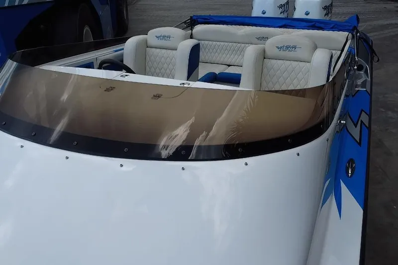  Yacht Photos Pics 2021 Velocity 290sc boat with white and blue interior, featuring a sleek windshield design.