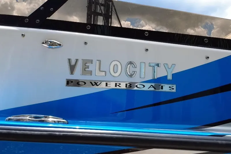  Yacht Photos Pics 2021 Velocity 290sc powerboat with blue and white design, featuring "Velocity Powerboats" logo.