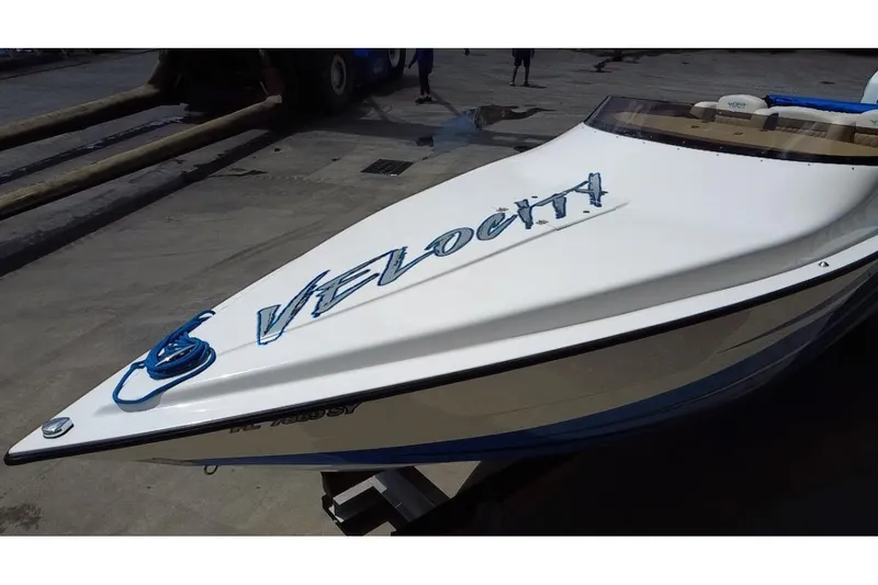  Yacht Photos Pics 2021 Velocity 290sc speedboat on a dock, featuring sleek design and bold lettering.