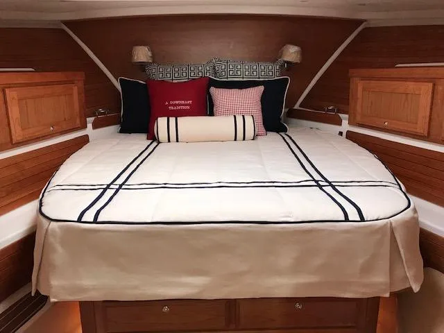  Yacht Photos Pics Luxurious cabin interior of 2026 Back Cove 372 yacht with elegant bedding and wooden accents.