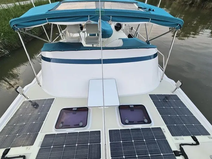 Carmella Yacht Photos Pics Kadey-Krogen 44AE 2019 yacht with solar panels and blue canopy on deck.