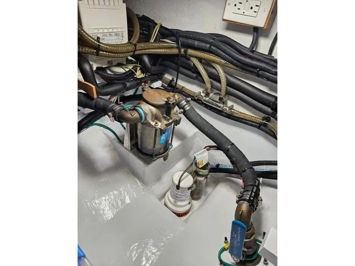 Carmella Yacht Photos Pics Engine room of 2019 Kadey-Krogen 44AE yacht with visible pipes and machinery.