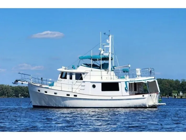 Carmella Yacht Photos Pics 2019 Kadey-Krogen 44AE yacht on calm water under clear blue sky.