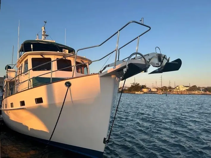 Carmella Yacht Photos Pics Kadey-Krogen 44AE 2019 yacht docked at sunset, reflecting on calm water.