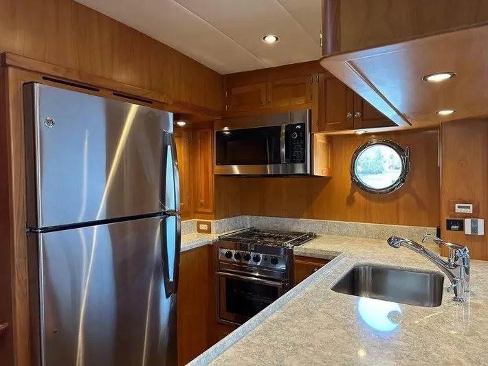 Carmella Yacht Photos Pics Modern kitchen in 2019 Kadey-Krogen 44AE yacht with stainless steel appliances and porthole window.