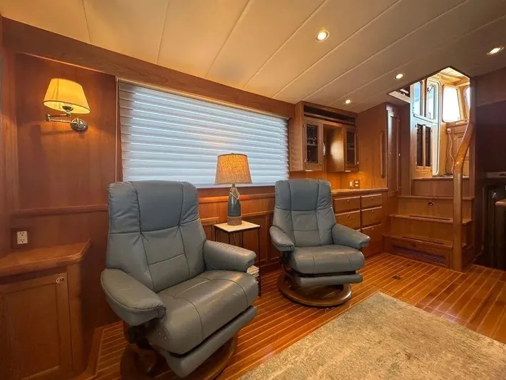 Carmella Yacht Photos Pics Luxurious interior of 2019 Kadey-Krogen 44AE yacht with plush seating and elegant wood finishes.