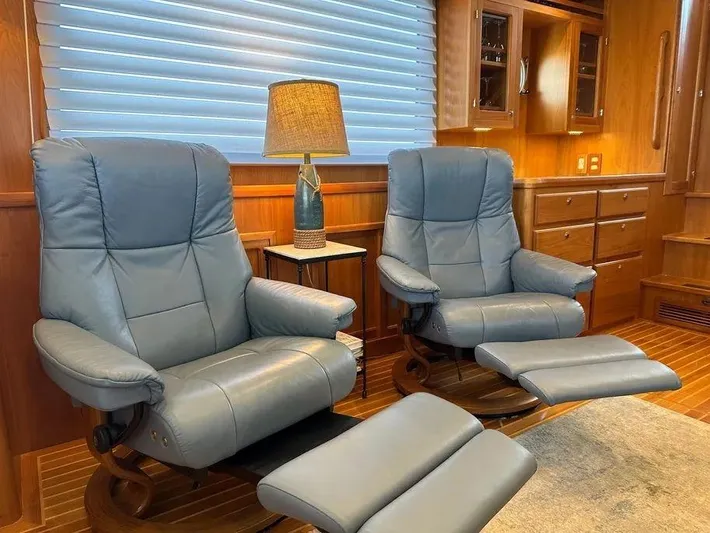 Carmella Yacht Photos Pics Luxurious Kadey-Krogen 44AE 2019 yacht interior with blue recliners and elegant wood finish.