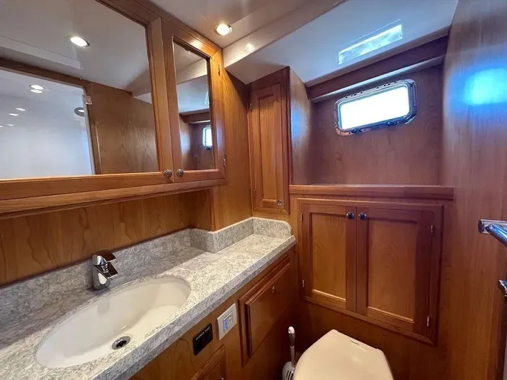 Carmella Yacht Photos Pics Luxurious Kadey-Krogen 44AE 2019 yacht bathroom with wood cabinetry and modern fixtures.