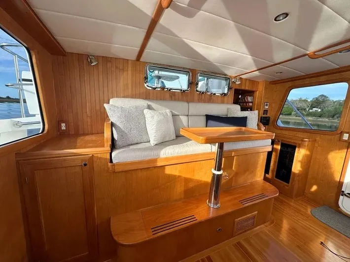 Carmella Yacht Photos Pics Luxurious 2019 Kadey-Krogen 44AE yacht interior with wooden finish and comfortable seating.