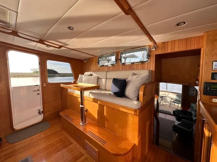 Carmella Yacht Photos Pics Luxurious interior of 2019 Kadey-Krogen 44AE yacht with plush seating and wooden accents.
