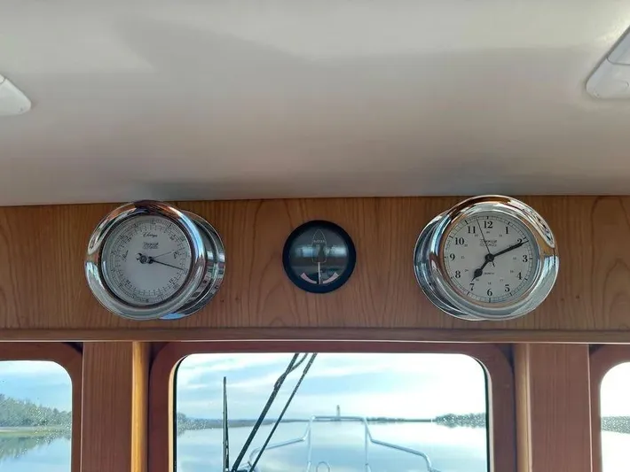 Carmella Yacht Photos Pics Interior of 2019 Kadey-Krogen 44AE yacht with clock and barometer on wooden panel.